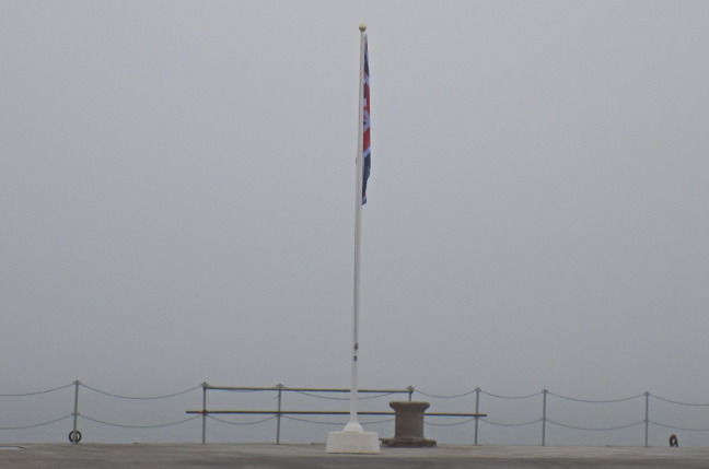 A Union Flag stands limp in fog at HM Naval Base Portsmouth A Union Flag stands limp in fog at HM Naval Base Portsmouth