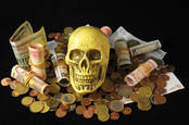 A skull atop money