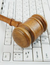 Gavel on keyboard, image courtesy of Shutterstock