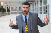 Businessman rocking golden necklace with dollar sign