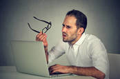 Man confused by laptop